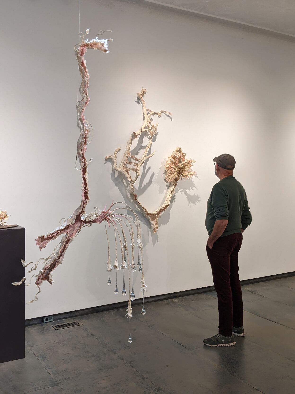 A man views works in a gallery